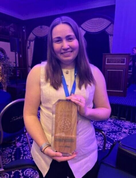Emma Doble holding the judges' special recognition award at the Patient Engagement Open Forum: Made with Patients awards ceremony