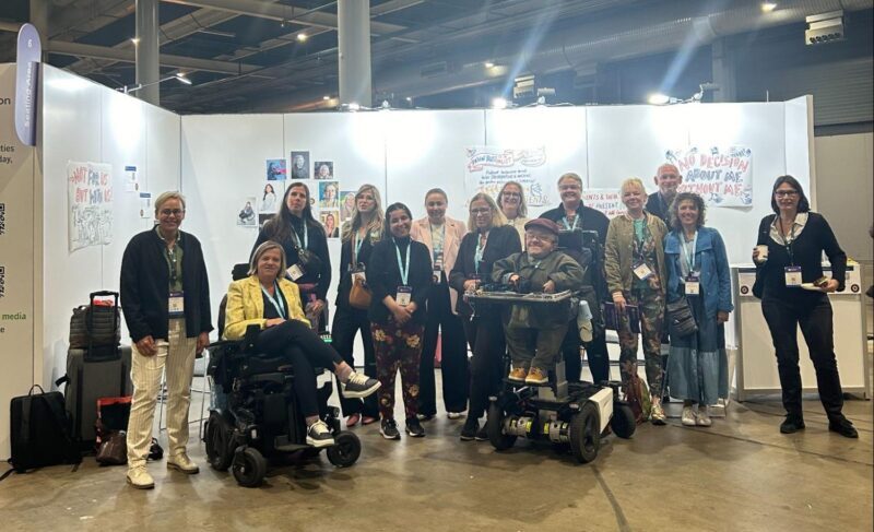 Attendees and patient advocates interacting at the lived experience booth at the International Forum in Utrecht, where delegates discussed co-production in research.